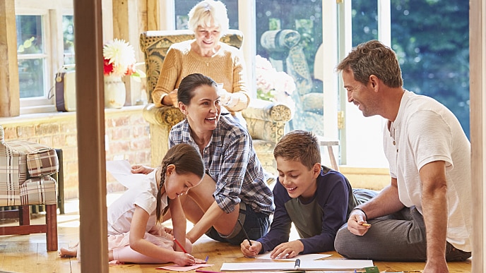 Eine Familie, die zusammen schreibt und lächelt